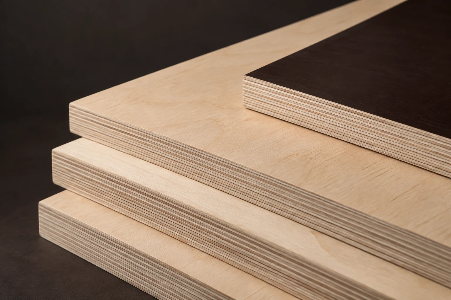 Illustrative close-up of layered birch plywood and a dark film-faced panel